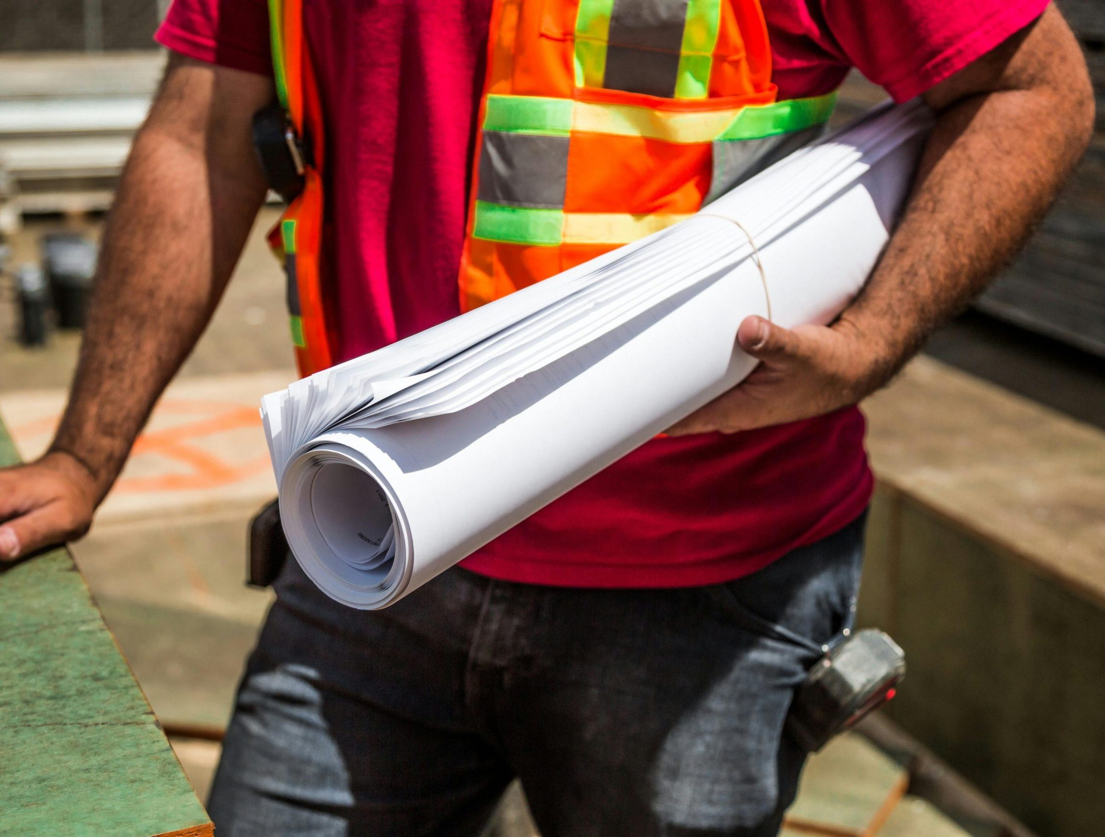 Construction worker holding paper