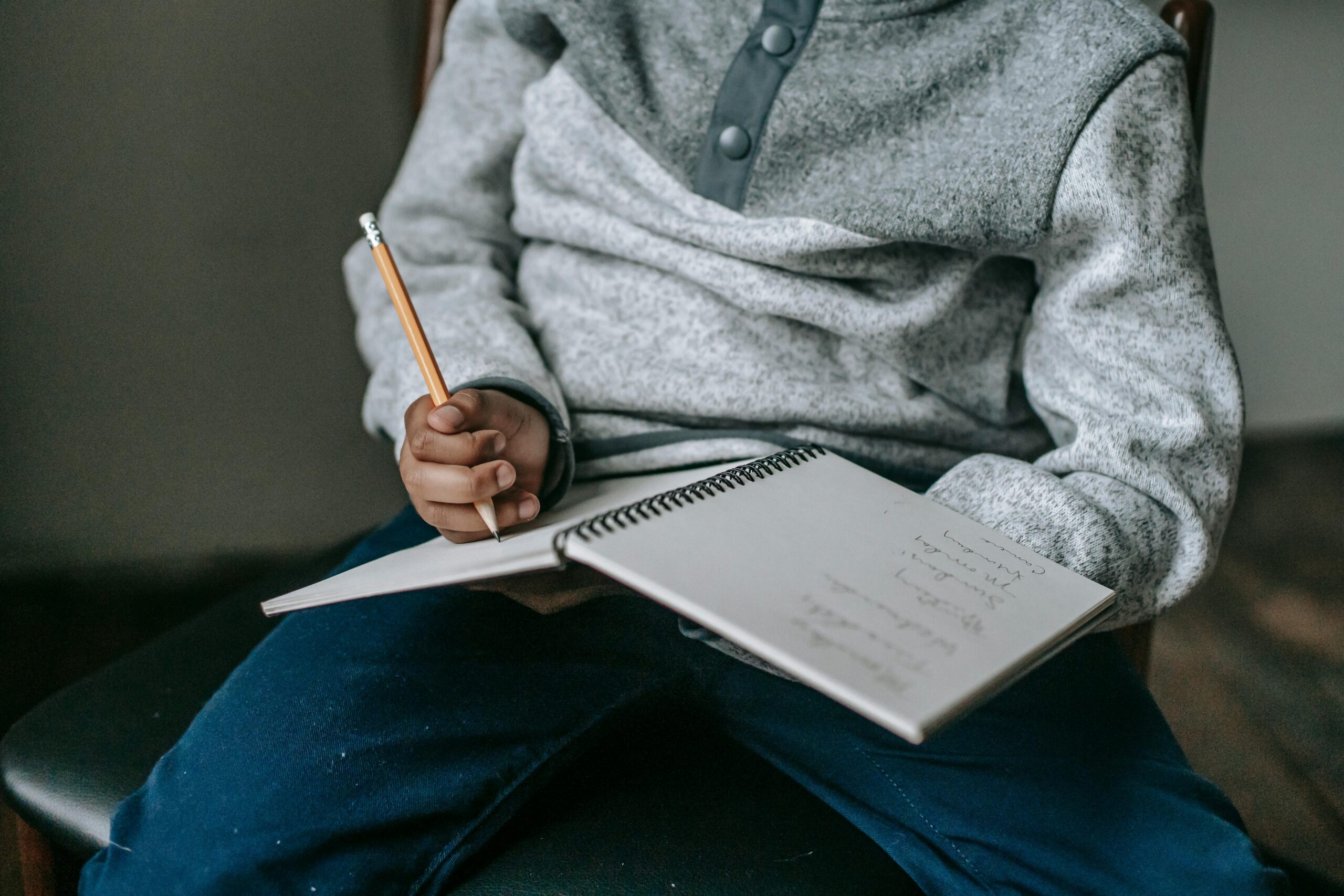 Child writing in book