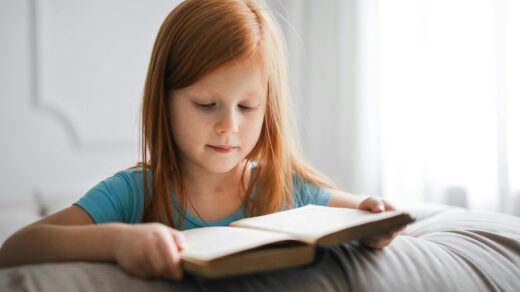 Child in blue shirt reading