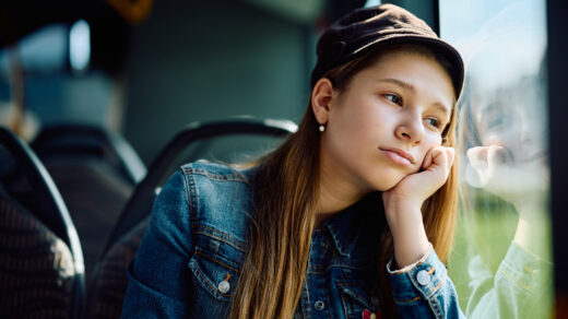 Girl looking sad as she sits on bus