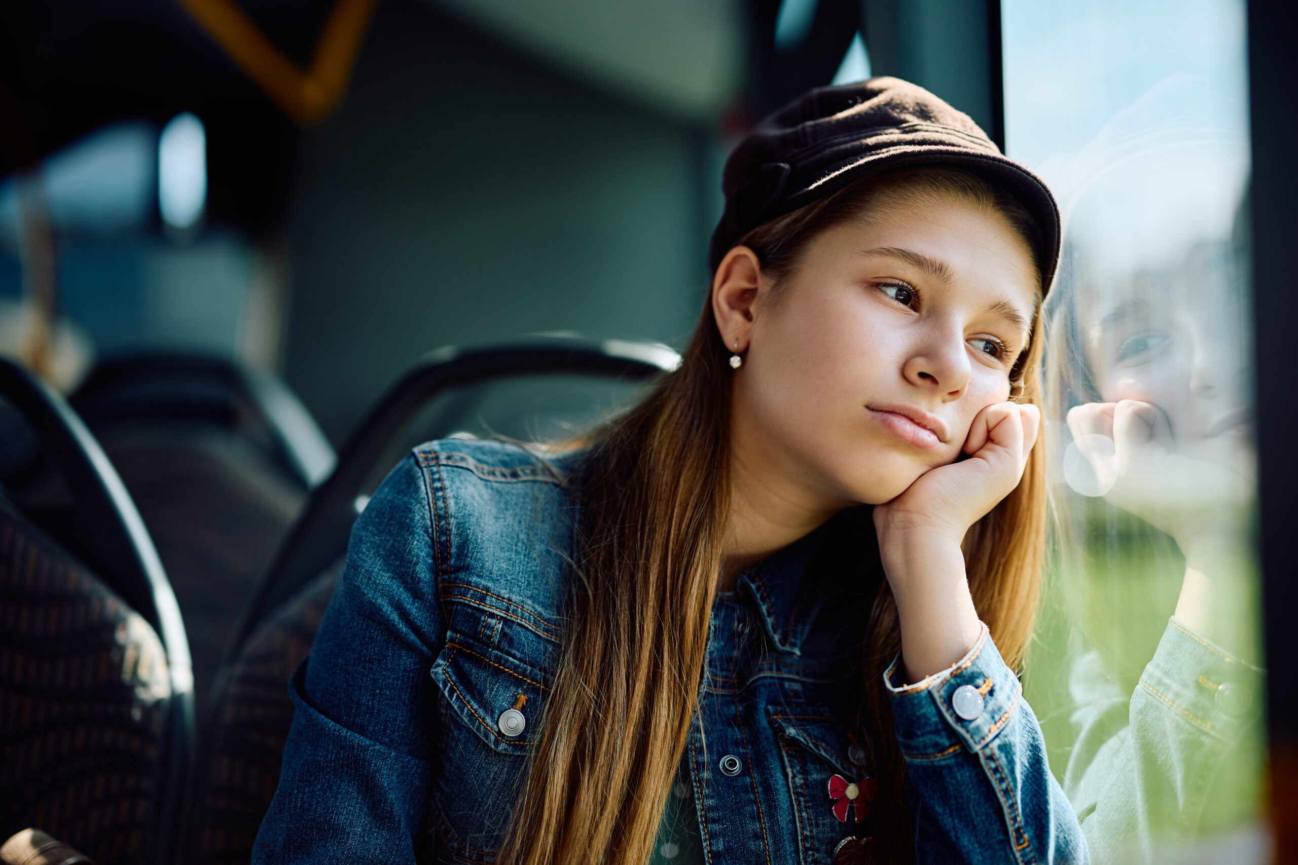 Girl looking sad as she sits on bus