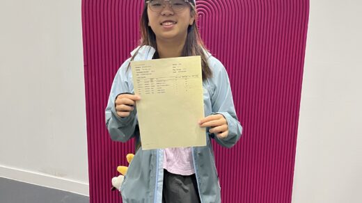 Tin Yau Lai from St John Bosco Arts College holding results