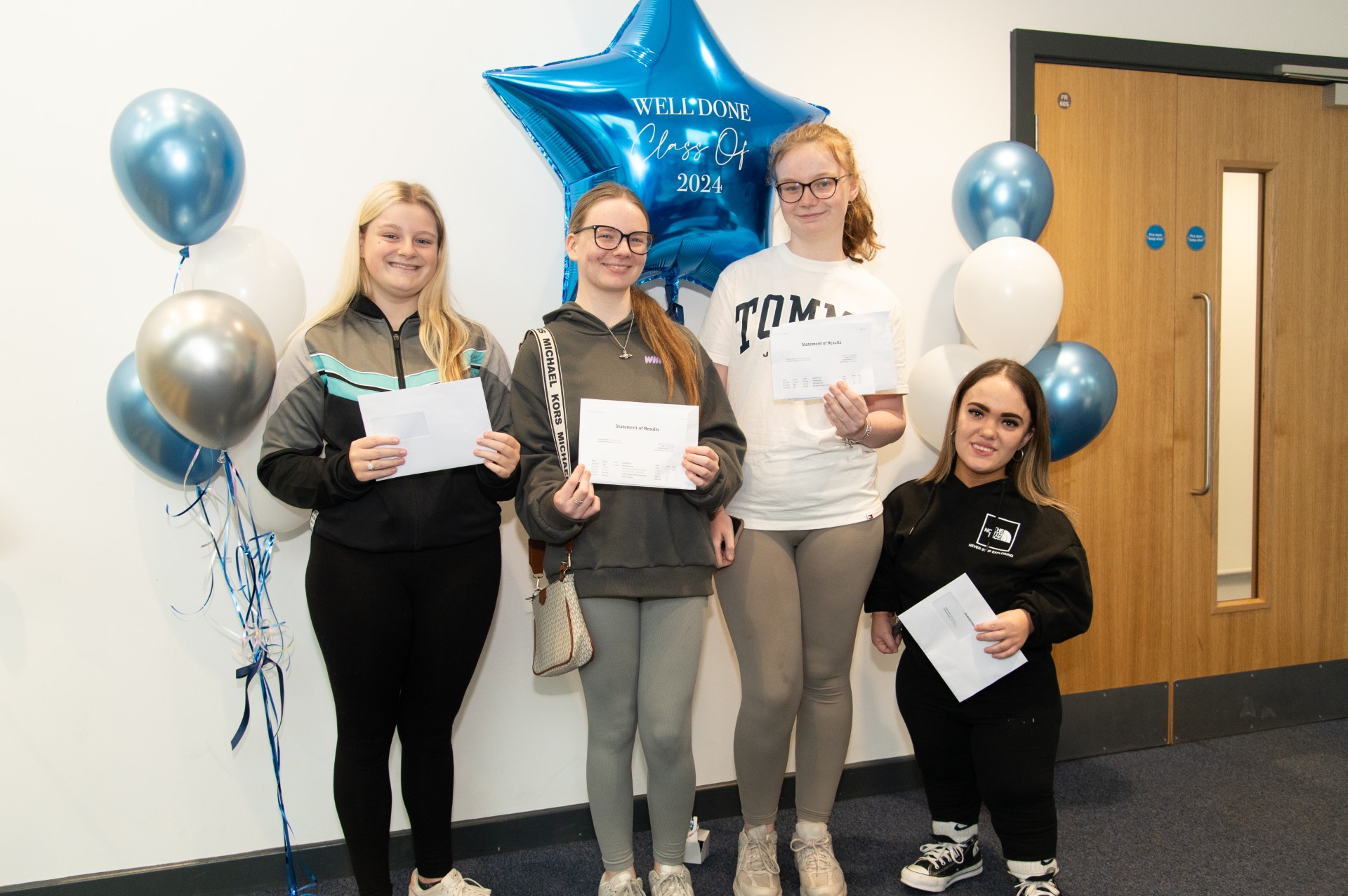 St John Plessington students proudly hold up their results