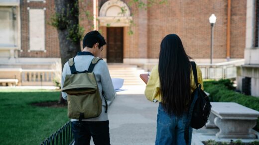 Male and female student walking to school