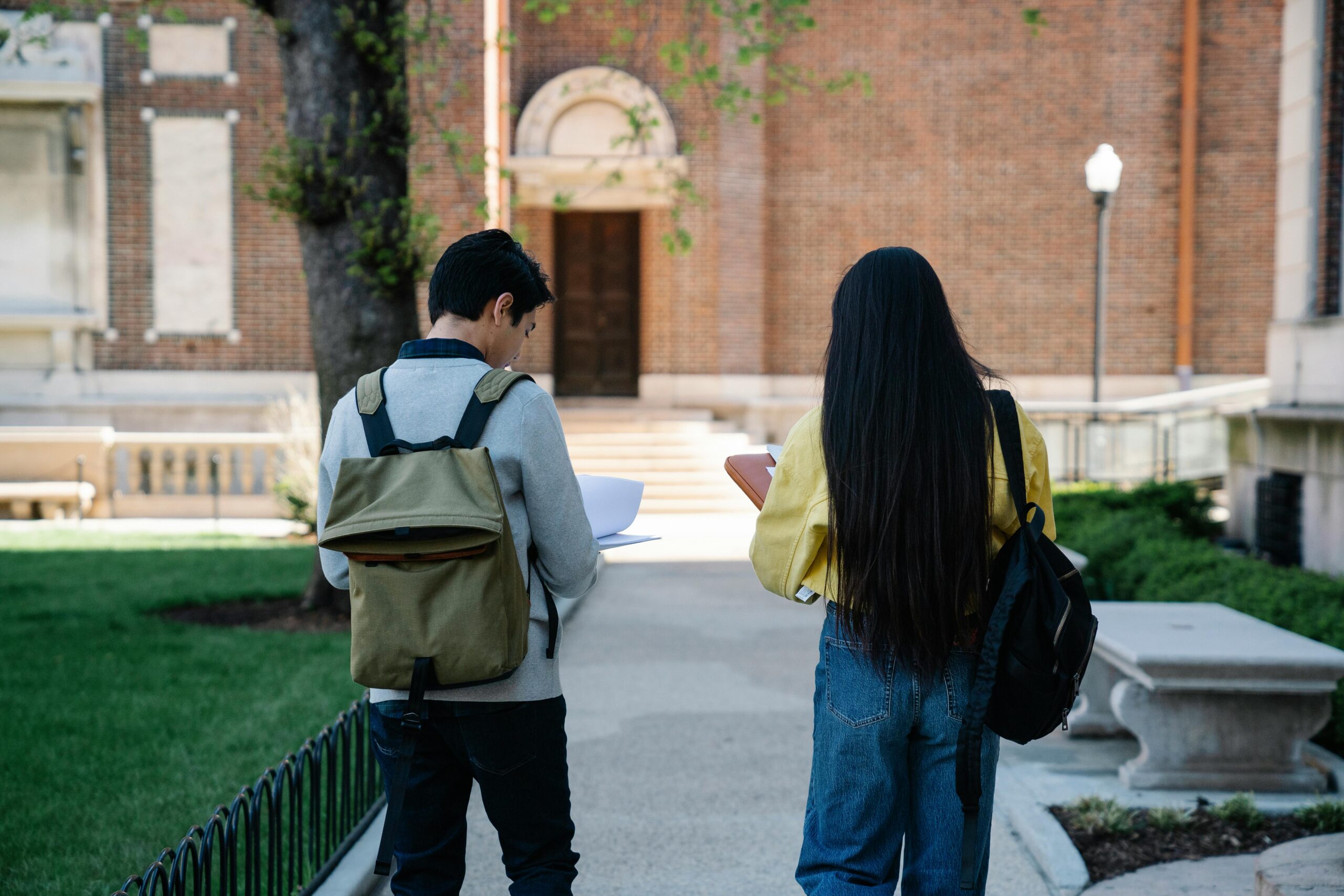 Male and female student walking to school