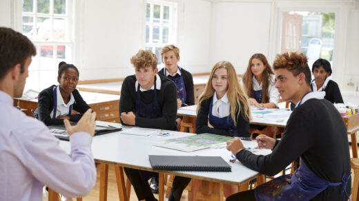 Teenage Students Listening To Teacher In Art Class