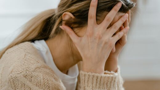 Stressed person covering their face