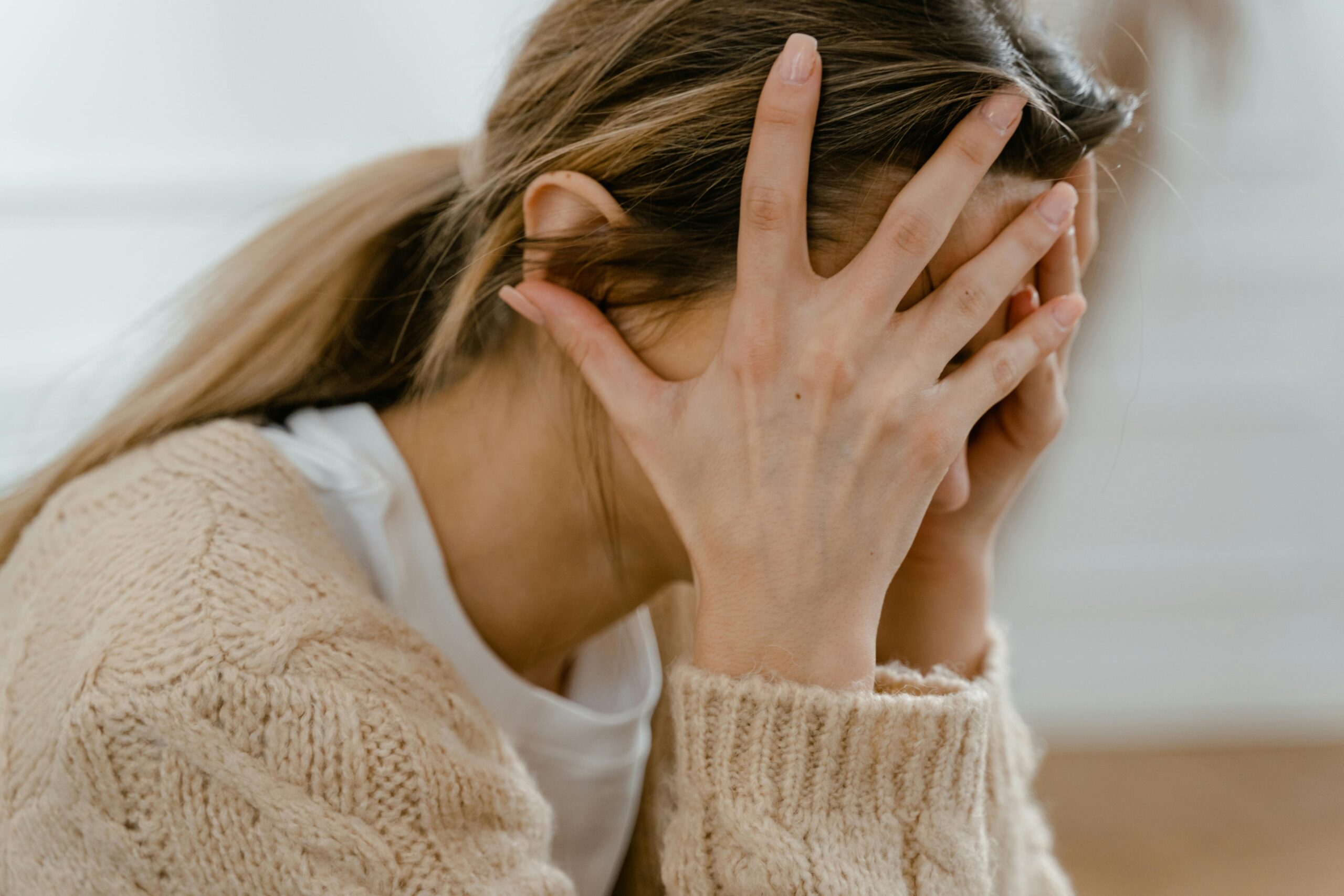 Stressed person covering their face