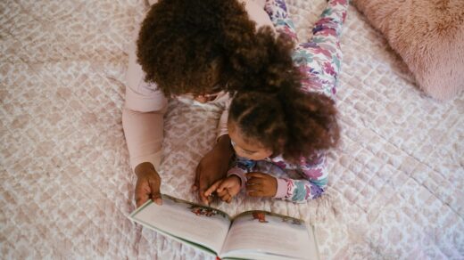 Child and parent reading together