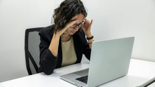 Tired employee sitting in-front of laptop