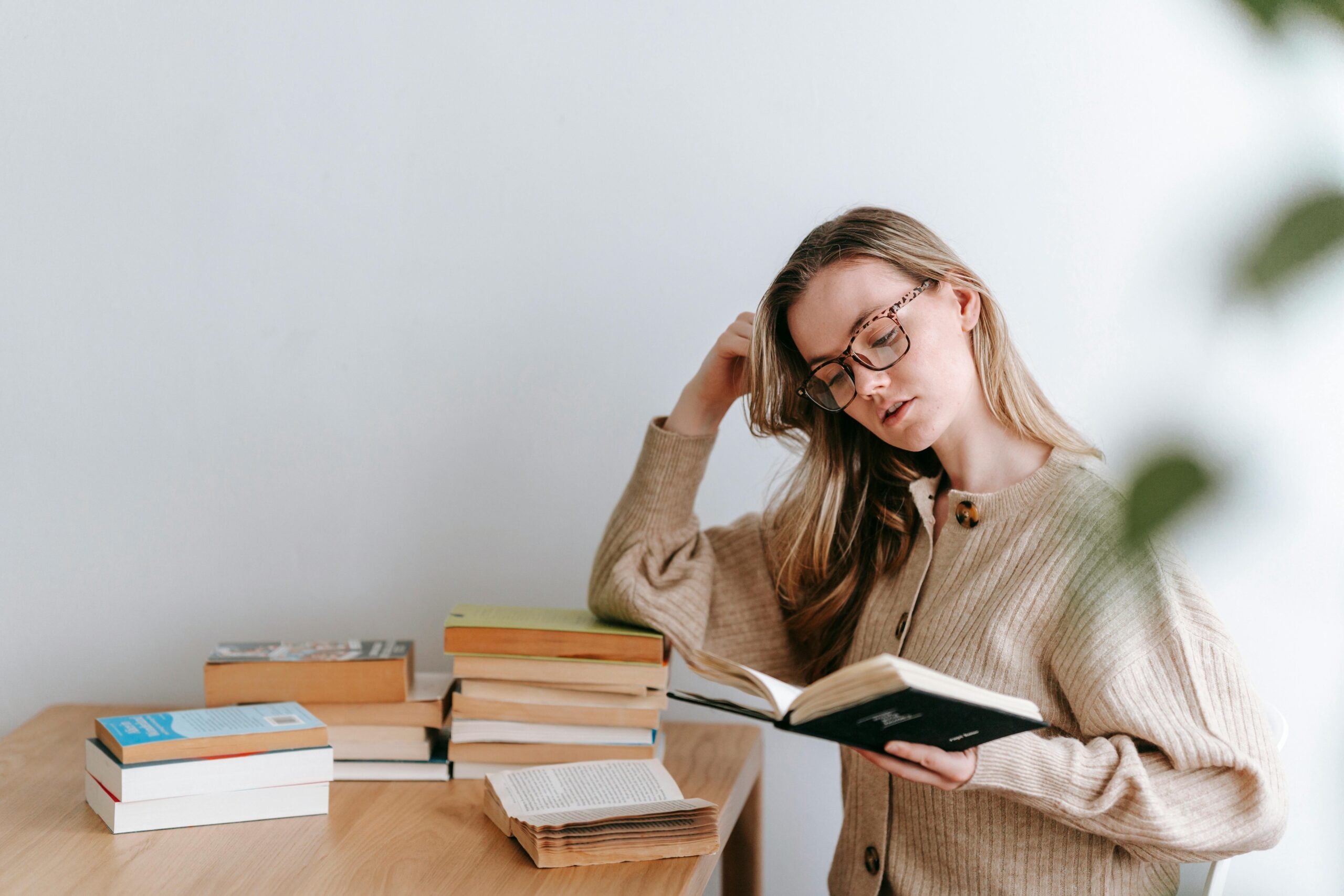 Young person reading books