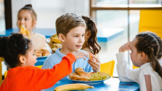 Young children eating school meal