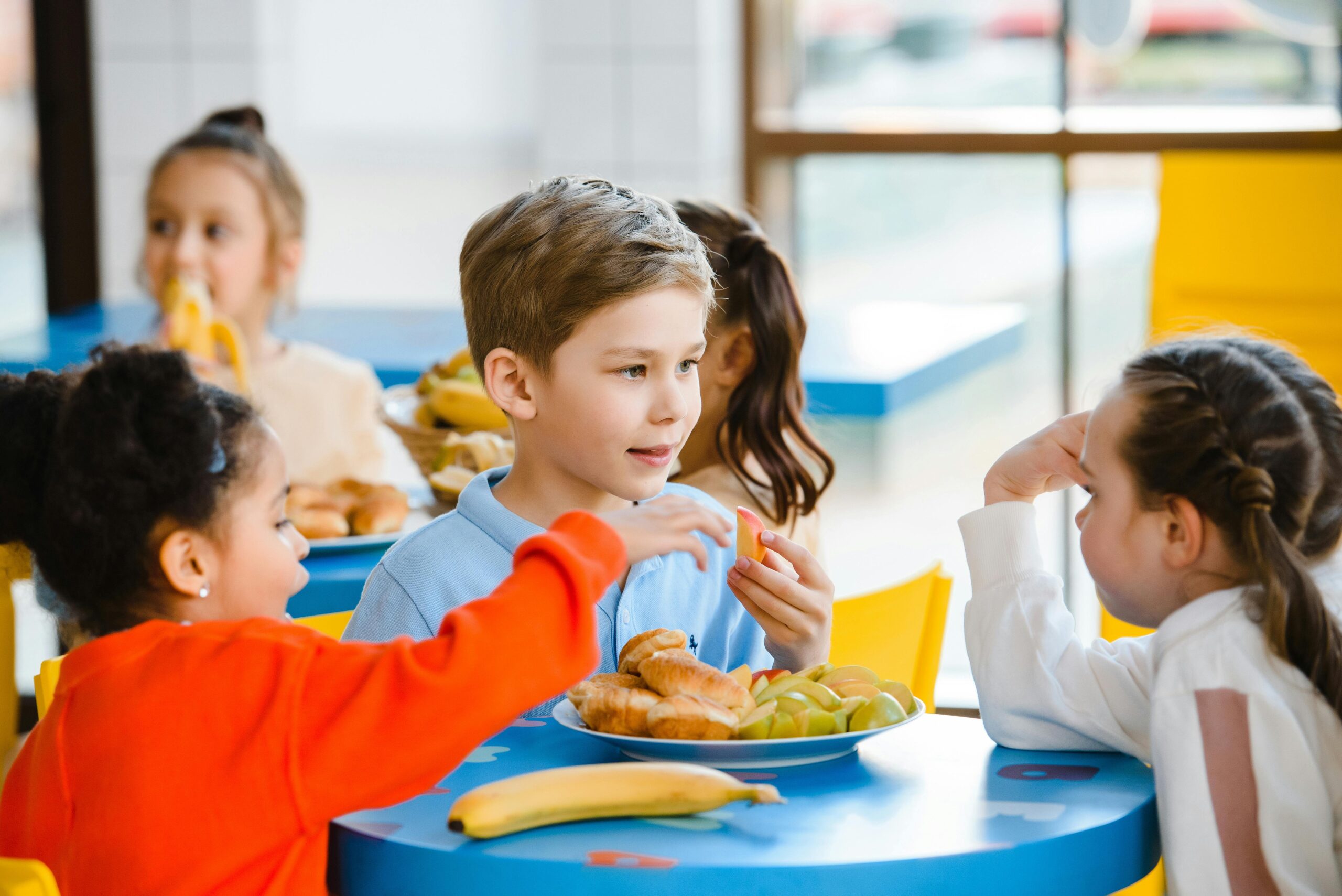 Young children eating school meal