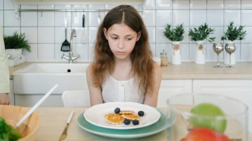 Girl sat in-front of plate