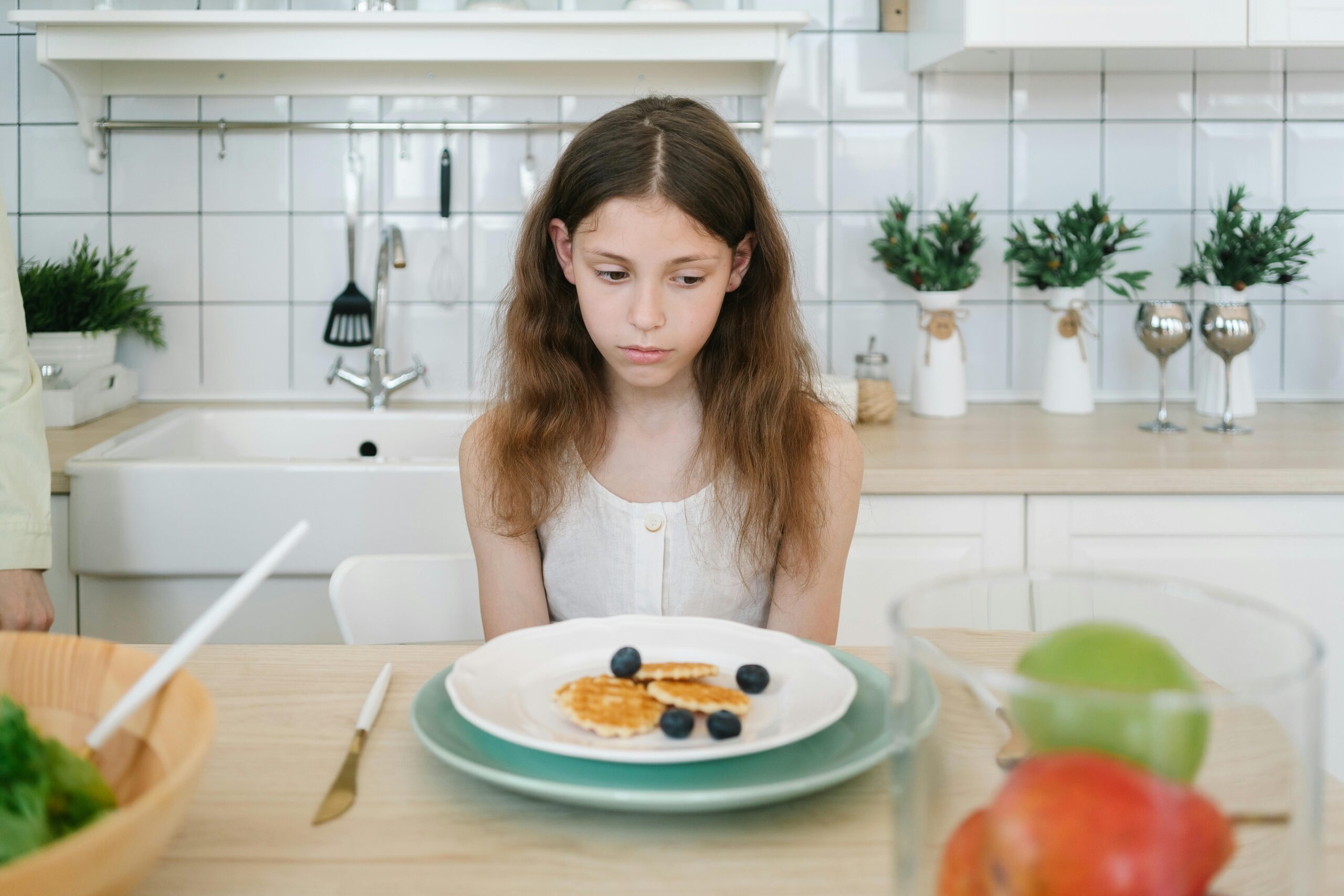 Girl sat in-front of plate